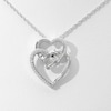 0.085 CT. T.W. Diamond Double Heart with Square Knot Pendant in Sterling Silver