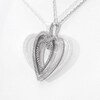 0.116 CT. T.W. Diamond and Textured Double Heart Pendant in Sterling Silver