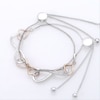 0.04 CT. T.W. Diamond Interlocking Sideways Heart and Infinity Bolo Bracelet in Sterling Silver and 10K Rose Gold - 9.5"